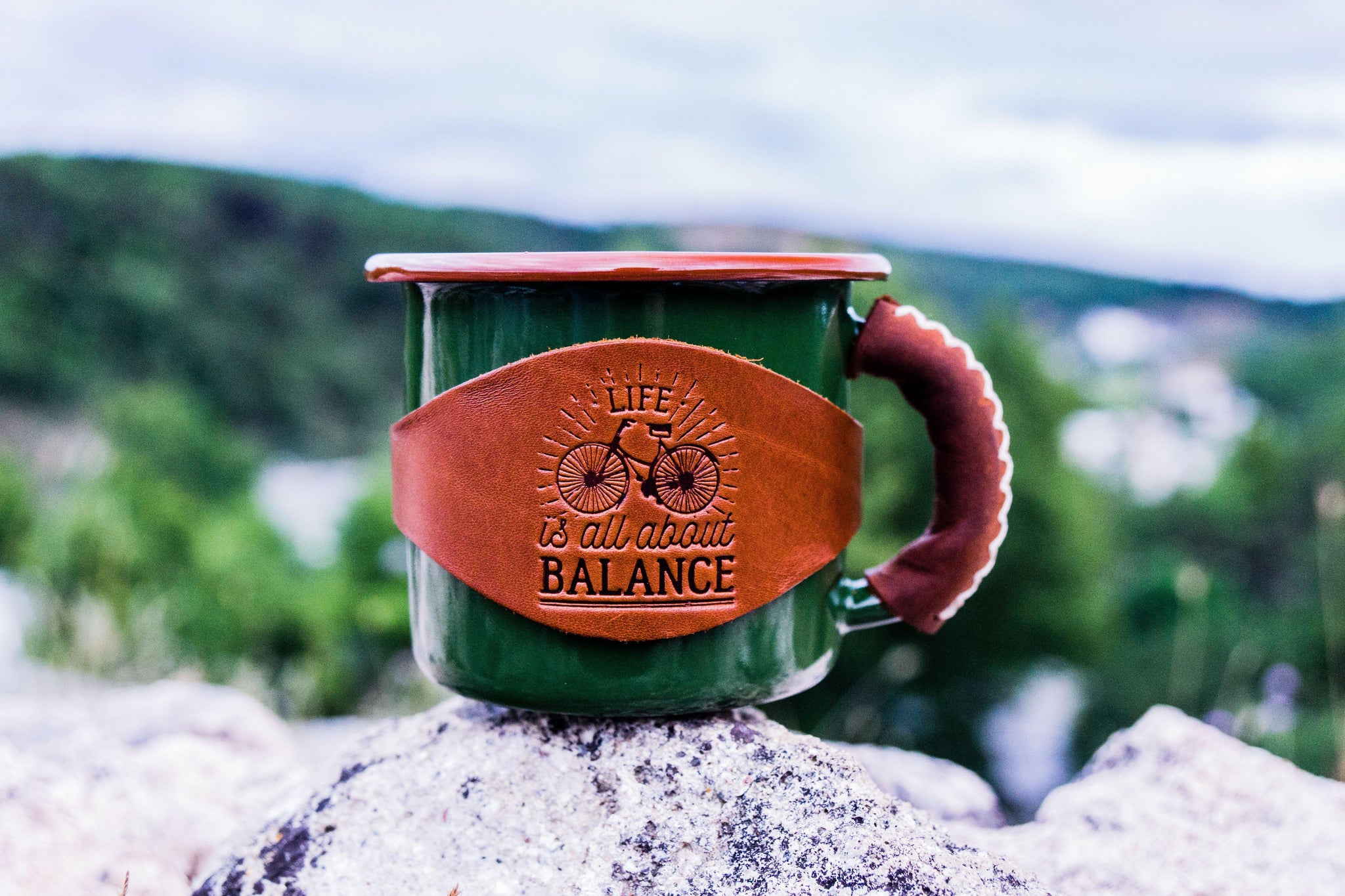 https://www.galenleather.com/cdn/shop/products/enamel-mug-with-leathered-handle-green_2048x.jpg?v=1537366945